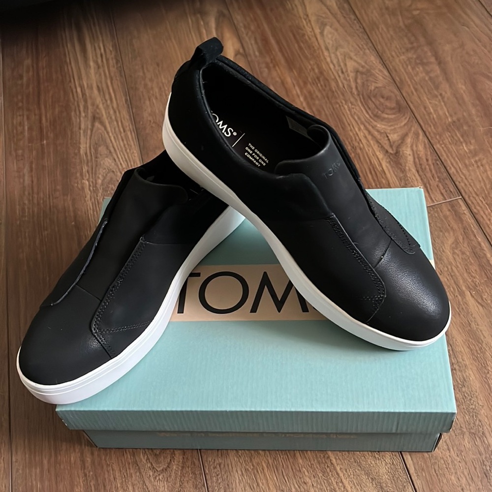 Toms woman’s black leather and suede slip on sneaker